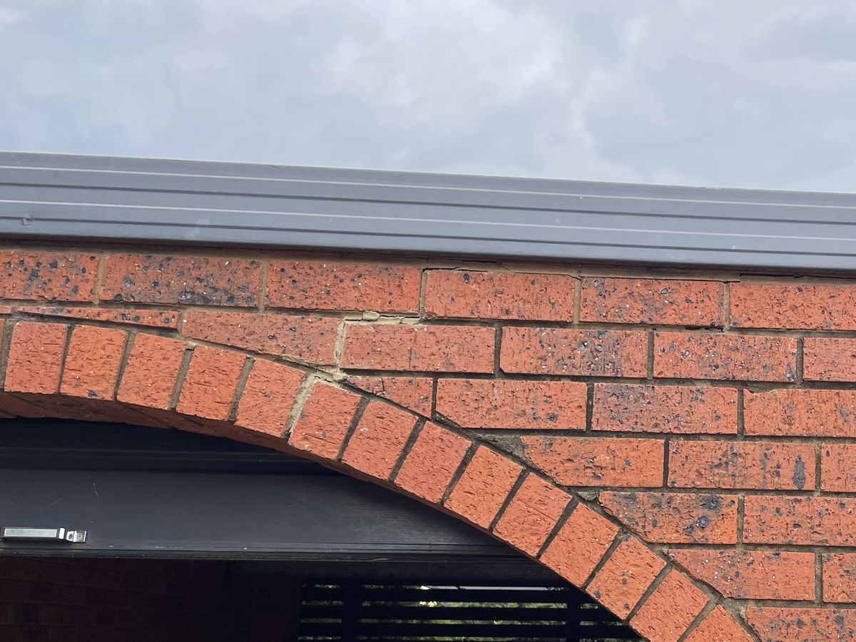 After: the same archway with the crack closed to a hairline and the gap at the roofline shut