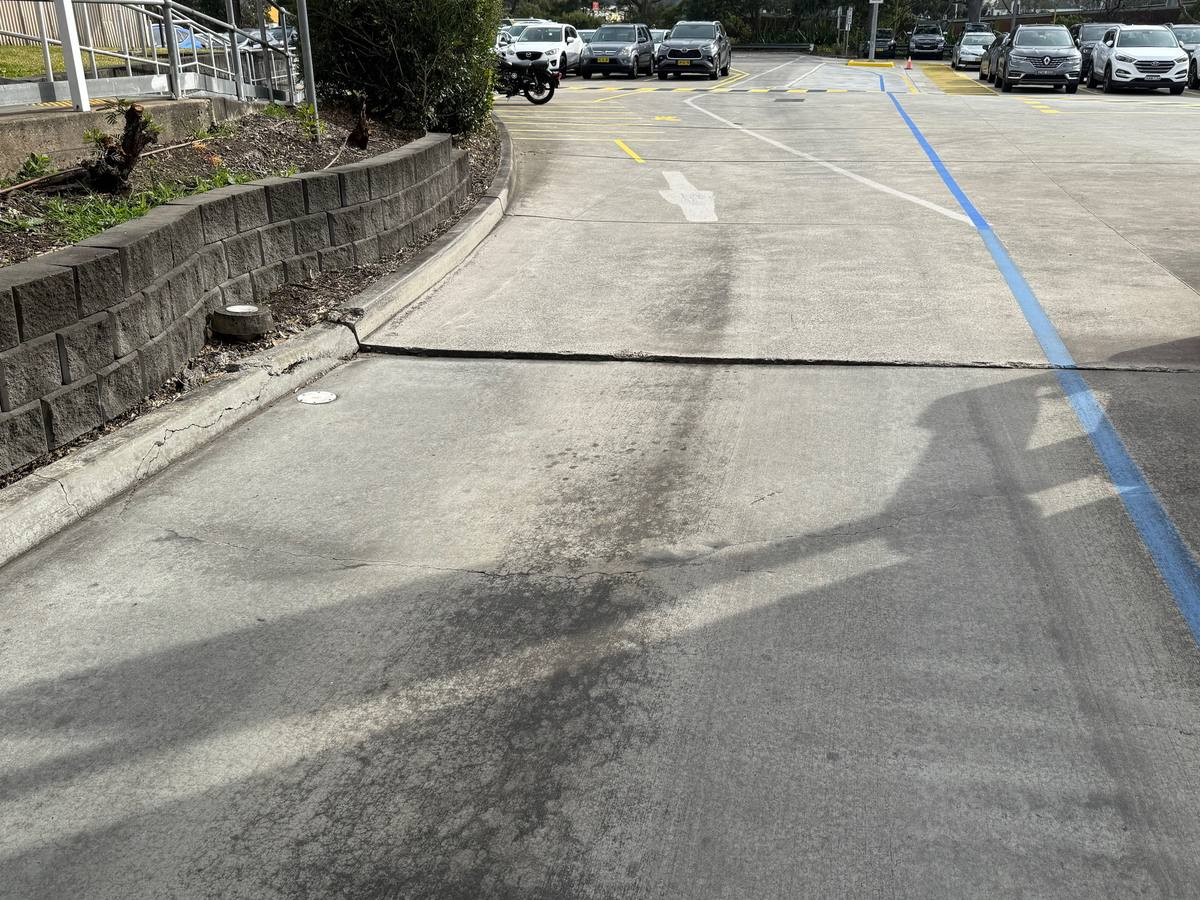 Before: driveway slab dropped at the joint, leaving a raised trip-edge