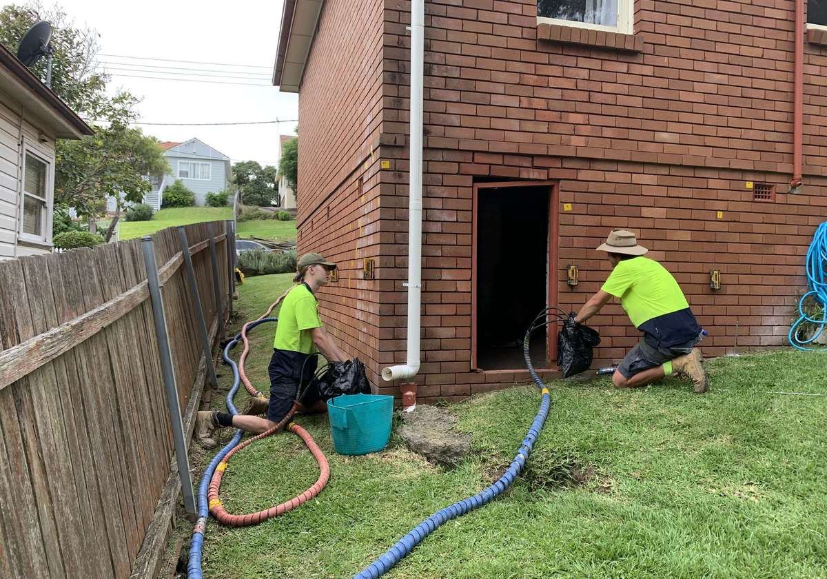 Resinject crew working at a residential brick home